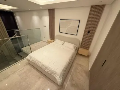 a bedroom with a white bed and a glass door at Sterling West House in Dubai