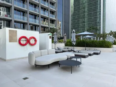 a seating area with a couch and tables and buildings at Sterling West House in Dubai