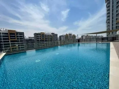 a large swimming pool on the roof of a building at Vogue Al Maktoum City Sobha Hartland Waves Near to Downtown, Burj Khalifa and Dubai Mall, One Bedroom Apartment plus Kids room with Balcony and City View, Access to all Amenities in Dubai