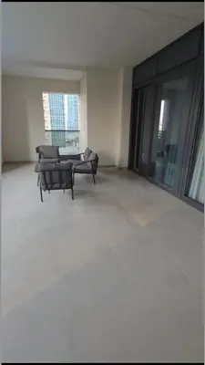 a living room with a table and chairs in a building at Act Tower 410 in Dubai