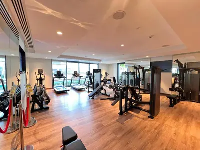 a gym with treadmills and exercise equipment in a building at Act Tower 410 in Dubai