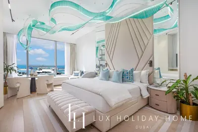 a bedroom with a bed and a view of the ocean at LUX Iconic Views at The Palm Tower Studio 4 in Dubai