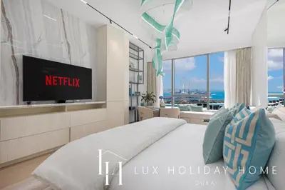 a bedroom with a bed and a tv in a room at LUX Iconic Views at The Palm Tower Studio 4 in Dubai