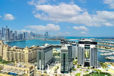 an aerial view of a city with buildings and a body of water at LUX Iconic Views at The Palm Tower Studio 4 in Dubai