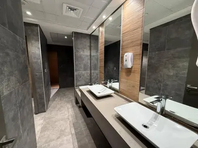 a bathroom with two sinks and a large mirror at Canal View Studio AG Tower in Dubai