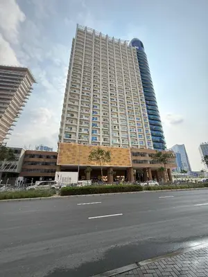 a large building with a street in front of it at Canal View Studio AG Tower in Dubai