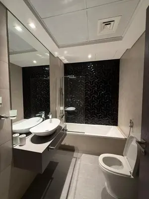 a bathroom with a toilet and a sink and a shower at Canal View Studio AG Tower in Dubai