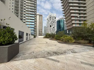 an empty courtyard in a city with tall buildings at Canal View Studio AG Tower in Dubai