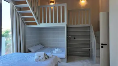 a bedroom with a bunk bed and a staircase at World Class 6 BDR Villa In Signature Palm in Dubai
