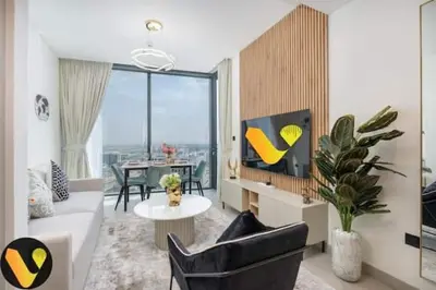 a living room with a couch and a tv at Vogue Al Maktoum City Sobha Hartland Waves Near to Downtown, Burj Khalifa and Dubai Mall, One Bedroom Apartment plus Kids room with Balcony and City View, Access to all Amenities in Dubai