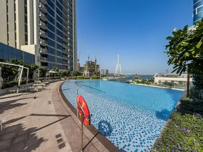 a large swimming pool on the side of a building at StayShort - Luxury 1 Bedroom Apartment in Dubai Marina Sleeps 4 in Dubai
