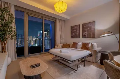 a bedroom with a bed and a living room at StayShort - Luxury 1 Bedroom Apartment in Dubai Marina Sleeps 4 in Dubai
