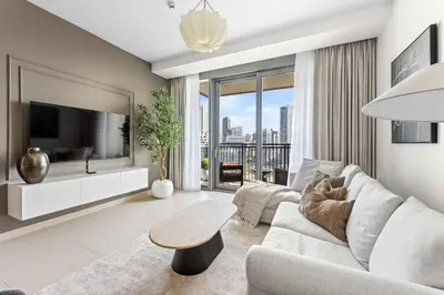 a living room with a couch and a tv at StayShort - Luxury 1 Bedroom Apartment in Dubai Marina Sleeps 4 in Dubai