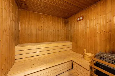 a wooden sauna with a wooden tub in a room at Emerald Luxury Suite DMCC Metro station in Dubai