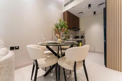 a dining room with a table and chairs at HAVN - 1 bedroom in Torino, Al Barsha in Dubai