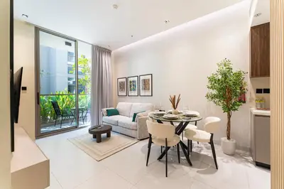 a living room with a table and a couch at HAVN - 1 bedroom in Torino, Al Barsha in Dubai