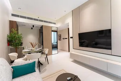 a living room with a large flat screen tv on a wall at HAVN - 1 bedroom in Torino, Al Barsha in Dubai