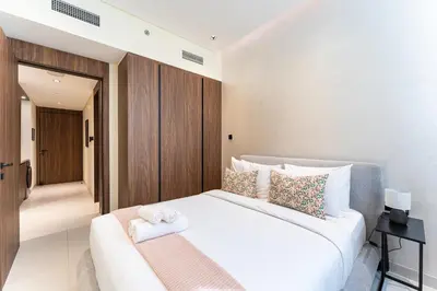 a bedroom with a large white bed with pillows at HAVN - 1 bedroom in Torino, Al Barsha in Dubai