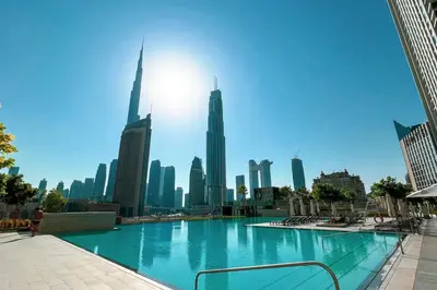 a large swimming pool with a city skyline in the background at Mahogany 21 - 4BR - Dubai Mall Walk & Burj Khalifa in Dubai