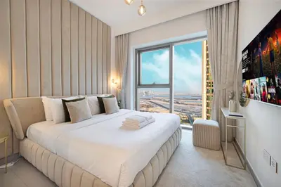 a bedroom with a large bed with a large window at Mahogany 21 - 4BR - Dubai Mall Walk & Burj Khalifa in Dubai