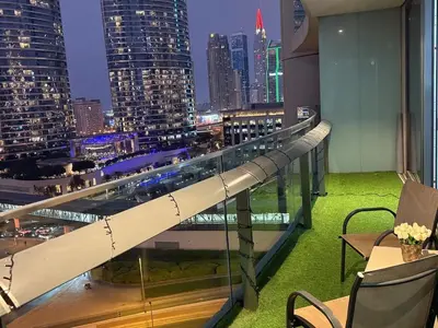 a view of a city at night from a building at Central Downtown 1BR - Walk to Dubai Mall in Dubai