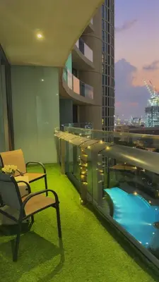 a hotel room with a swimming pool and a building at Central Downtown 1BR - Walk to Dubai Mall in Dubai