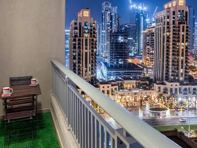 a balcony with a view of a city at night at Downtown Dubai 1BR - 2BR Full Burj Khalifa View in Dubai