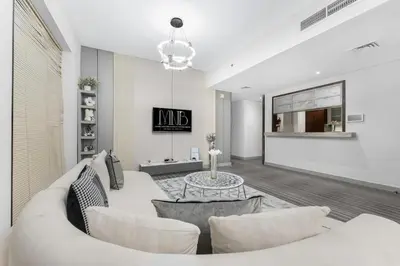 a living room with a white couch and a table at Downtown Dubai 1BR - 2BR Full Burj Khalifa View in Dubai