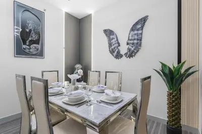 a dining room with a table with chairs and a pineapple at Downtown Dubai 1BR - 2BR Full Burj Khalifa View in Dubai