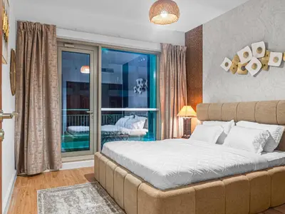 a bedroom with a large bed and a balcony at Downtown Dubai 1BR - 2BR Full Burj Khalifa View in Dubai