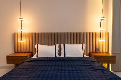a bedroom with a bed with two night stands and two lamps at 3BR apartment in the one of the tallest tower in Marina in Dubai