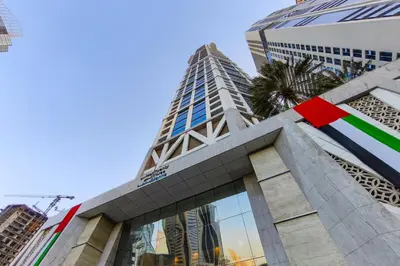 a building in the city with a red ribbon on it at 3BR apartment in the one of the tallest tower in Marina in Dubai