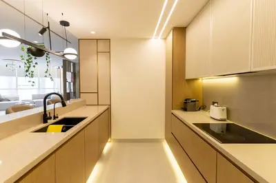 a kitchen with wooden cabinets and a sink at 3BR apartment in the one of the tallest tower in Marina in Dubai