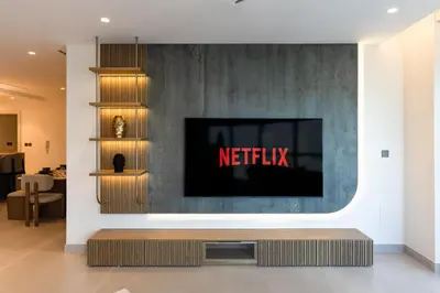 a television on a wall with a netflix sign on it at 3BR apartment in the one of the tallest tower in Marina in Dubai