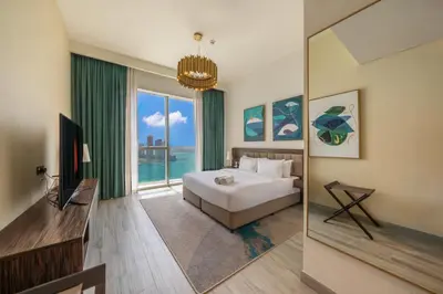 a bedroom with a bed and a large window at Prestige Heights 1BR with Iconic Oceanview in Dubai
