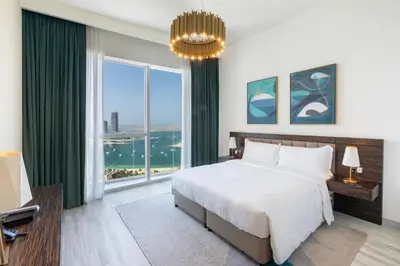 a bedroom with a large bed and a large window at Prestige Heights 1BR with Iconic Oceanview in Dubai