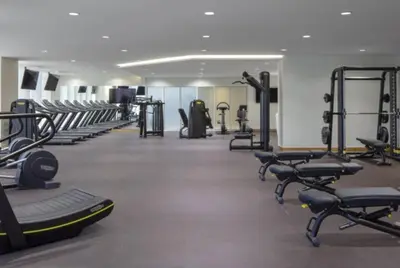 a gym with several rows of treadms and machines at Prestige Heights 1BR with Iconic Oceanview in Dubai