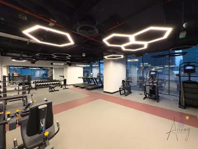 a gym with treadmills and elliptical machines at Luxury Modern 1BR Paragon by Igo Downtown 1BR in Dubai