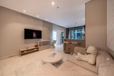 a living room with a teddy bear sitting on a couch at Sleek & Glam Downtown Studio Near Burj Khalifa in Dubai