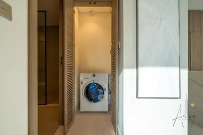 a washer and dryer in a walk in closet at Luxe Missoni-Inspired 1BR Sky-High Living in Dubai