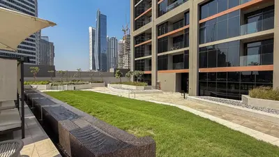 a large building with a lawn in front of it at Luxe Missoni-Inspired 1BR Sky-High Living in Dubai