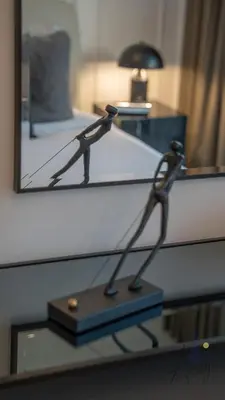 a lamp on a table in front of a mirror at Upscale 1BR Paragon by IGO Near Downtown in Dubai
