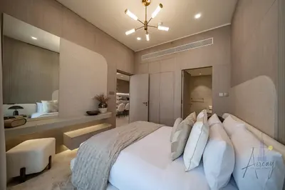a bedroom with a large white bed and a mirror at Urban Oasis 1BR Designer Nest Chic & Cosy in Dubai