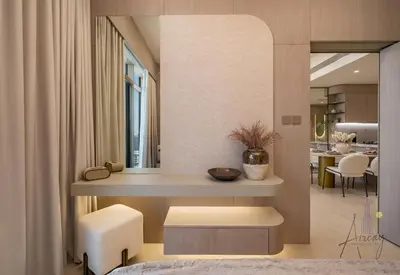 a living room with a table and two stools at Urban Oasis 1BR Designer Nest Chic & Cosy in Dubai