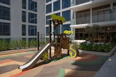 a playground in front of a building with a slide at Urban Oasis 1BR Designer Nest Chic & Cosy in Dubai