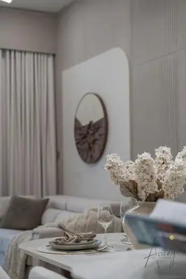 a living room with a couch and a table with wine glasses at Urban Oasis 1BR Designer Nest Chic & Cosy in Dubai