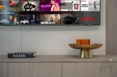 a tv on a wall with movies on it at Boutique 1BR Escape Cosy & Classy JVC in Dubai