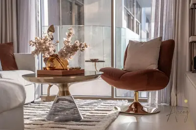 a living room with a chair and a table at Boutique 1BR Escape Cosy & Classy JVC in Dubai