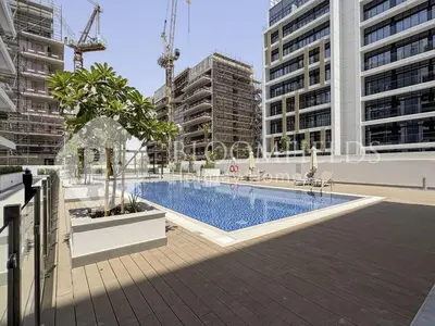 a swimming pool in a city with tall buildings at Bloomfields Modern STU Azizi Riviera in Dubai