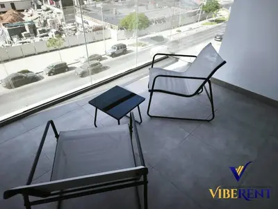 two chairs and a table in front of a window at Supreme joy in Arjan 1 BHK in Dubai